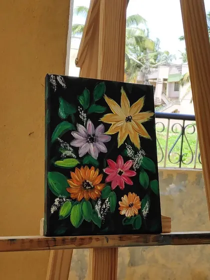 The floral painting on an easel, seen from a slight angle.