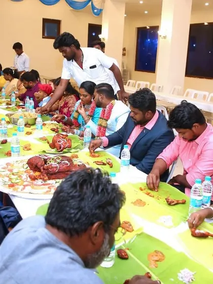 A wide shot of the main family table enjoying the grand feast together.