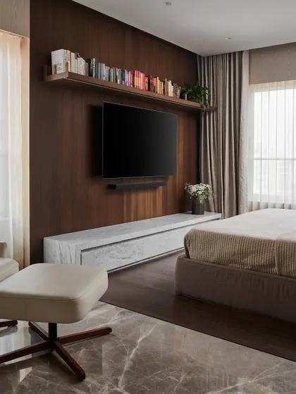 The master bedroom is a tranquil oasis, free of heavy visual elements. A floating Carrara marble TV console and a simple floating bookshelf create a clean, bold statement against a dark wood accent wall.