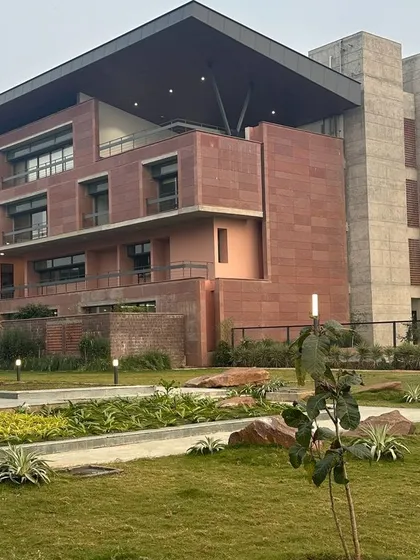 The fast-track building at Azim Premji University in Bhopal, clad in local Farsi sandstone. The design draws inspiration from the region's historical monuments, featuring climate-responsive elements like deep overhangs and north-south orientation to create a sustainable campus.