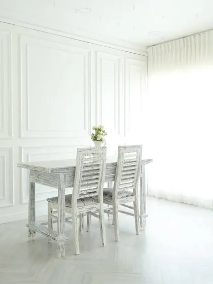This is the heart of my studio: an all-white, elegant space filled with natural light. The paneled walls, distressed furniture, and sheer curtains create a perfect canvas for everything from classic portraits and lookbooks to clean product photography.