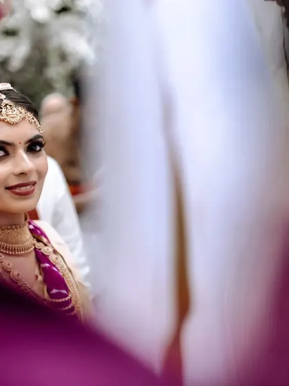A beautiful candid shot of the bride. Her smokey eye makeup adds a touch of modern drama to her traditional wedding look, creating a captivating and memorable style.