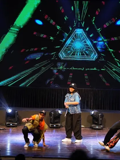 The crew hitting the floor with some ground moves during the hip hop performance. This showcases the athletic side of street dance.