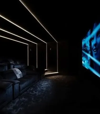 This side view shows how the linear lighting on the ceiling and walls can be used to create a sense of depth and architectural interest in a dark room.