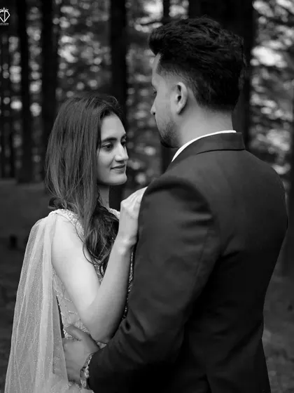 An intimate black and white close-up, focusing on the loving gaze shared between the couple.