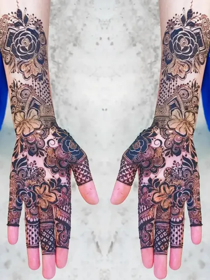 This design showcases a beautiful contrast between bold, dark floral patterns and lighter, intricate filler work. It's a modern take on the full coverage bridal look.