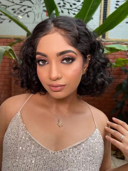 A soft, smokey eye look on a model with curly hair, showing the versatility of the techniques taught.