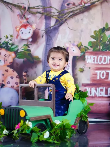 This little adventurer is all smiles as he stands in his jeep, ready to explore the wild.