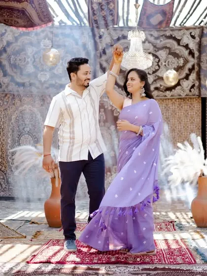 Dancing in a room adorned with beautiful carpets and a chandelier. This unique studio set in Pune provides a rich, bohemian, and luxurious backdrop for a romantic shoot.