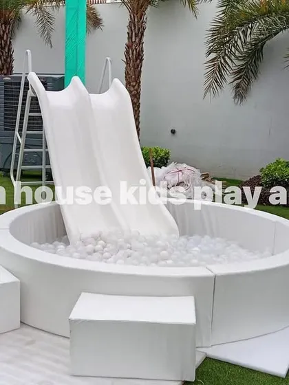 Our white round ball pool with a double slide set up on a lush green lawn, ready for a day of fun in the sun.