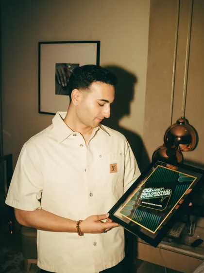 Holding my GQ 'Most Influential' award. This recognition highlights my position as a modern cultural figure, perfect for brands looking to connect with a contemporary audience.