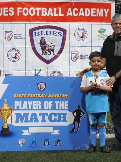 A young player receives the "Player of the Match" award from his proud father, showcasing the family-centric nature of our events.
