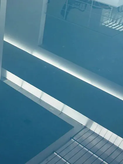 An abstract view of the reflections on the water, capturing the geometry of the space.