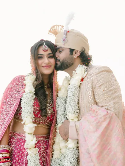 A sweet kiss for his bride. This photo captures the warmth and affection between the couple just after their ceremony.