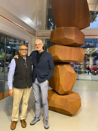 A portrait with artist Arik Levy next to his monumental sculpture. These collaborations are partnerships built on mutual respect for each other's craft.