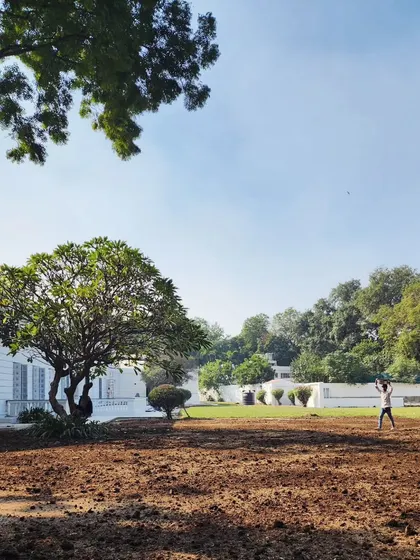 The "before" stage of a lawn renovation at a historic Delhi property, with the ground being prepared for a complete green makeover.