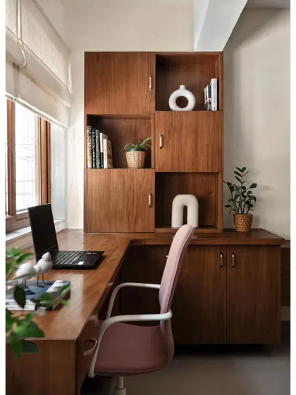 A mid-century modern approach was taken for the study, featuring clean lines and teak wood for the desk and storage unit. The design provides a smart, functional, and stylish workspace.