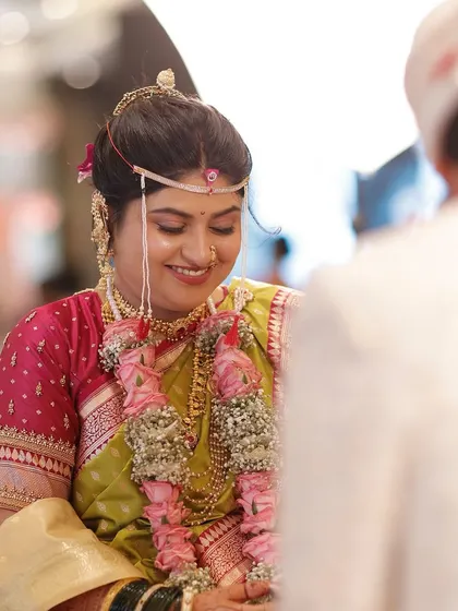The bride's smile during the rituals. The minimal makeup approach ensures she looks like herself, just more radiant, even in the most intimate moments.