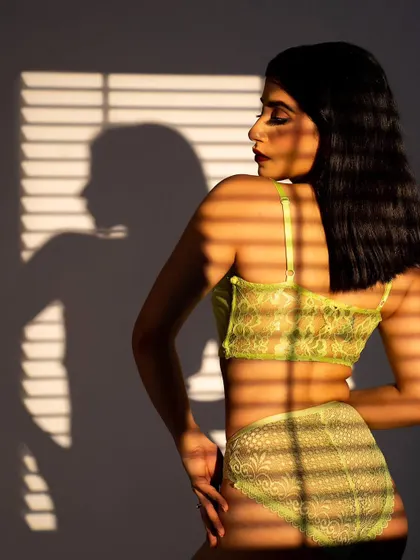 Another image from the same lingerie shoot, playing with light and shadow. The silhouette created by the shadow adds an interesting visual element to the composition.