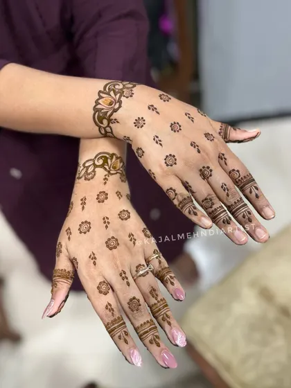A delicate and scattered floral design for the bride's sister. The tiny flowers and wrist cuff create a minimal and very trendy look.