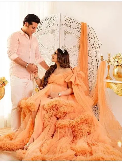 Another beautiful shot of the peach ruffled gown, this time with a statement bow. This dress is versatile and can be styled in different ways to suit your vision.