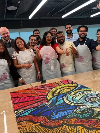 The proud LinkedIn team with their completed puzzle masterpiece. This isn't just a painting; it's a visual representation of their successful collaboration and a great piece of art for their office.