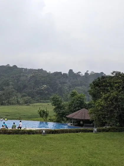 Another view of the beautiful infinity pool at Aurika Coorg, where team members can relax and soak in the serene landscape.
