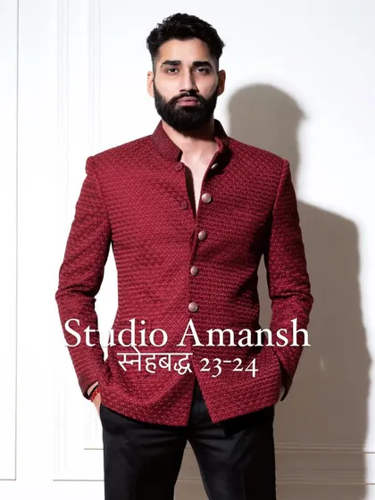 The front view of our crimson bandhgala, a piece that embodies confidence. The rich color and detailed fabric texture make it a perfect selection for a groom's reception outfit or a formal gala.