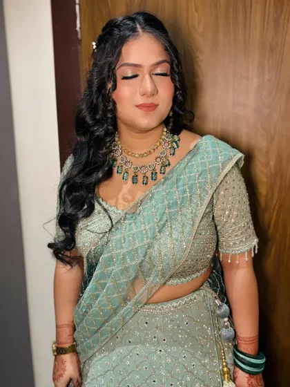 A close-up of her makeup with eyes closed, showing the soft shimmer on the lids.