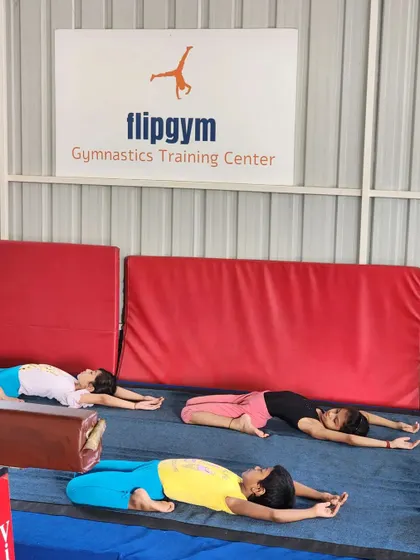Rest and recovery are part of training too. Students lie in a resting pose, allowing their muscles to relax after a challenging practice session.