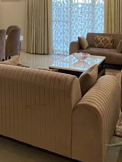 A close-up of the channel-tufted sofa in a soft pastel hue. This type of upholstery adds a sense of luxury and comfort, making the seating area both stylish and inviting.
