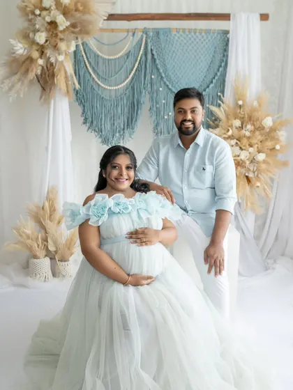 A picture-perfect portrait of the happy couple. Her light blue gown and his coordinated shirt create a soft and harmonious color palette against the boho-inspired backdrop.