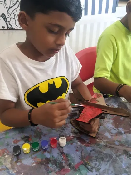 This young Batman fan is adding a splash of red to his airplane. Our workshops are a space for kids to merge their interests with our projects.