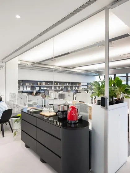 A view of our own office, showing the blend of collaborative tables and open workstations. Planters are used extensively to divide the space and create a healthy working environment.