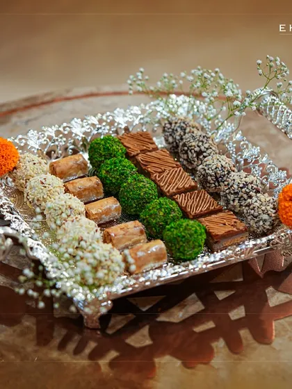 A luxury gifting collection perfect for the wedding season. This silver tray, laden with an assortment of fine chocolates and sweets, is a beautiful blend of elegance and indulgence.