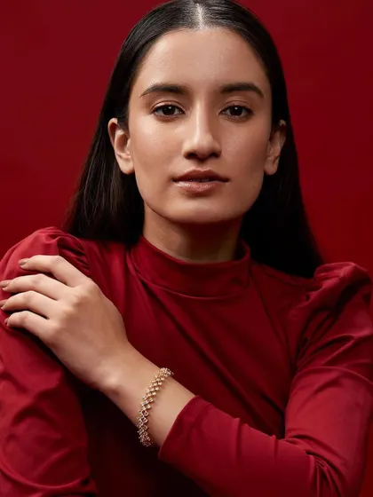 A simple and elegant portrait from the same jewelry campaign. The clean styling and direct gaze keep the focus on the model's natural beauty and the delicate bracelet.