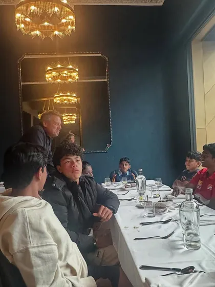 The team enjoying their dinner at an Indian restaurant, sharing stories from their tour.