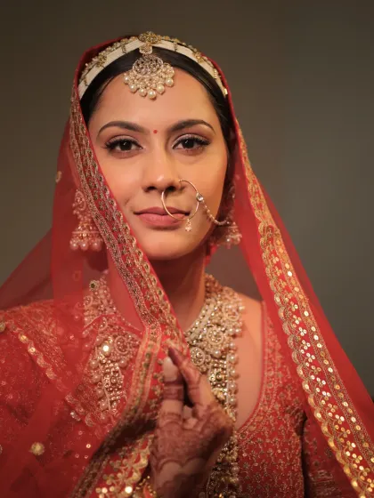 A close-up shot capturing the bride's soft and gentle expression. The makeup is minimal yet elegant, with perfectly defined eyes and a natural finish.
