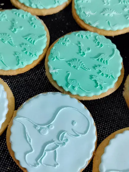 A close-up of the detail achieved with our T-Rex and dino pattern fondant stamps. They help you create professional-looking cookies with ease.
