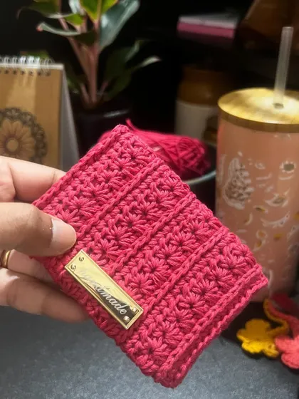 The finished "No Coin" wallet in a vibrant pink, complete with a golden "handmade" tag.