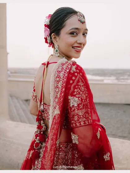 A happy, over-the-shoulder smile from the bride, a candid and charming portrait.
