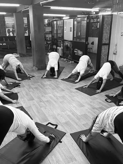 A powerful circle of Adho Mukha Svanasana or Downward-Facing Dog. This foundational pose energizes the entire body and is a key part of our Vinyasa flow classes.