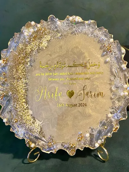 A beautiful engagement plaque for 'Arifa & Sarim', featuring a Quranic verse about love and mercy. The geode-style border and gold details make it a perfect keepsake.