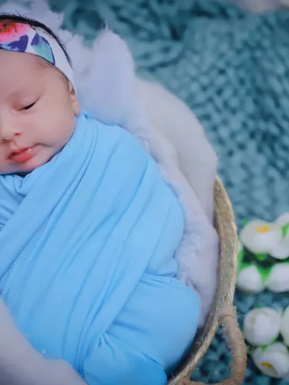 A close-up portrait of a peacefully sleeping newborn girl. Her delicate features are the star of the show in this simple, beautiful shot.