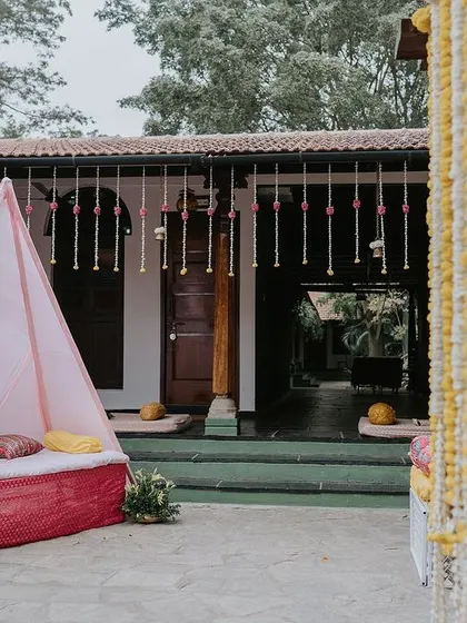 A wide view of the Haldi ceremony space, showing the teepee seating and the decorated mandap, creating a complete festive environment.