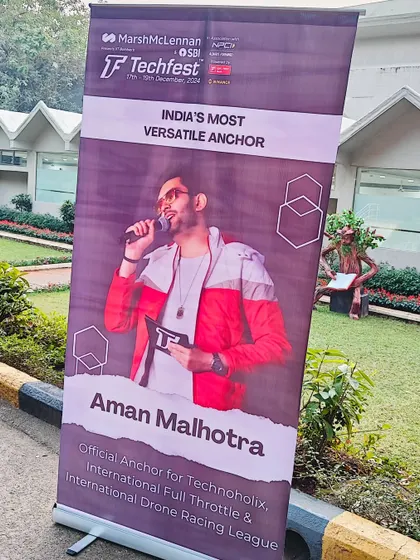 A closer look at the banner for Techfest, highlighting my role as 'India's Most Versatile Anchor' for events like Technoholix and the Drone Racing League.