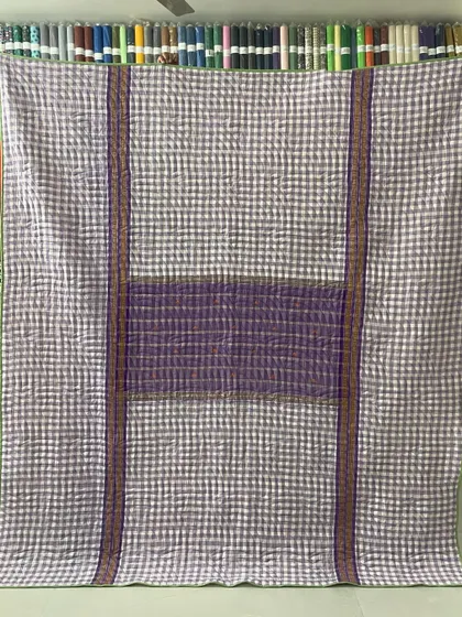 A collection of reversible memory quilts crafted from the sarees of a client's mother. Each side tells a different story, preserving the fabric's patterns and colors in a new, functional form.
