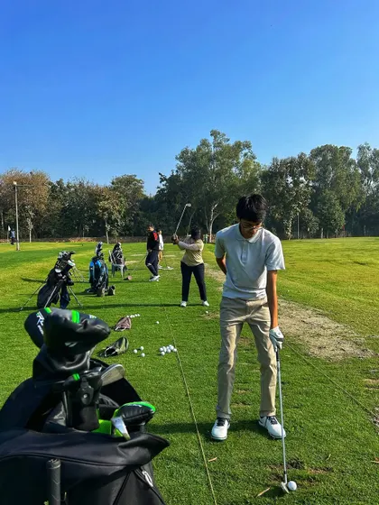 Locked, loaded, and ready to fire. A young golfer prepares for his shot on a busy Sunday.