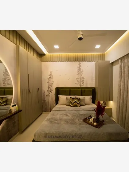 A full view of a master bedroom, showing the wardrobe, dressing table, and bed. The cohesive design and color palette create a harmonious and relaxing space.
