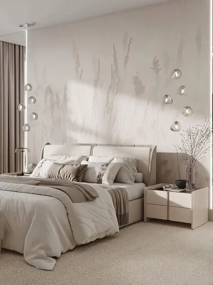 A serene bedroom with a beautiful, subtle wallpaper and delicate drop-down lights. The overall effect is calm, airy, and incredibly chic.